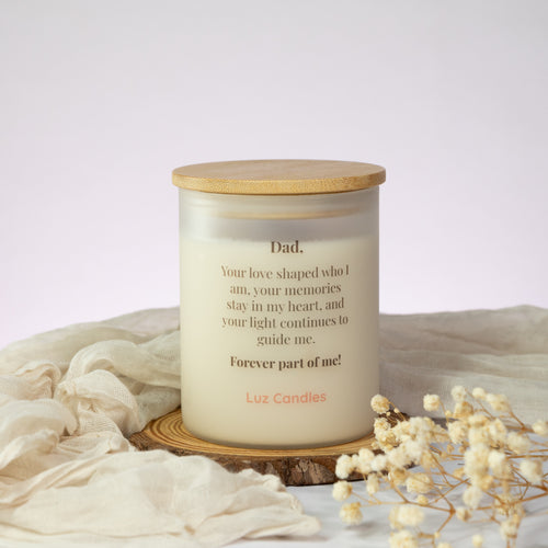 Luz Candles Au - A personalized soy wax candle from Luz Candles for Dad, featuring a clear glass jar with printed text, a light wood lid, and a rustic wood slice coaster, styled with draped cream fabric and dried baby's breath flowers.