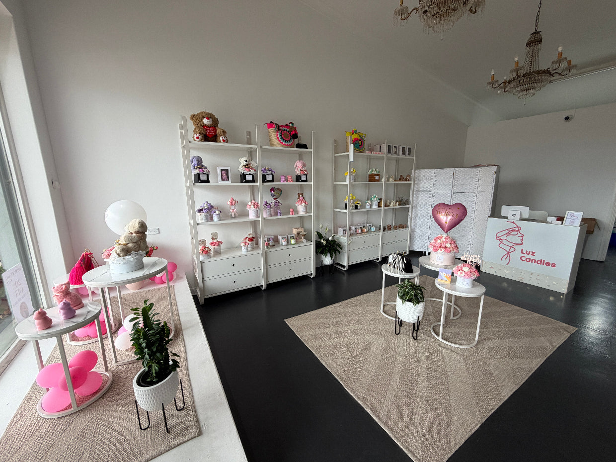 Luz Candles interior store decorative room with shelves, tables, and a chandelier.