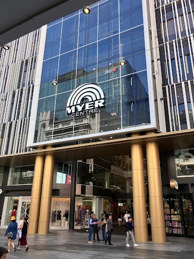 Myer Centre building with glass facade and people walking in front