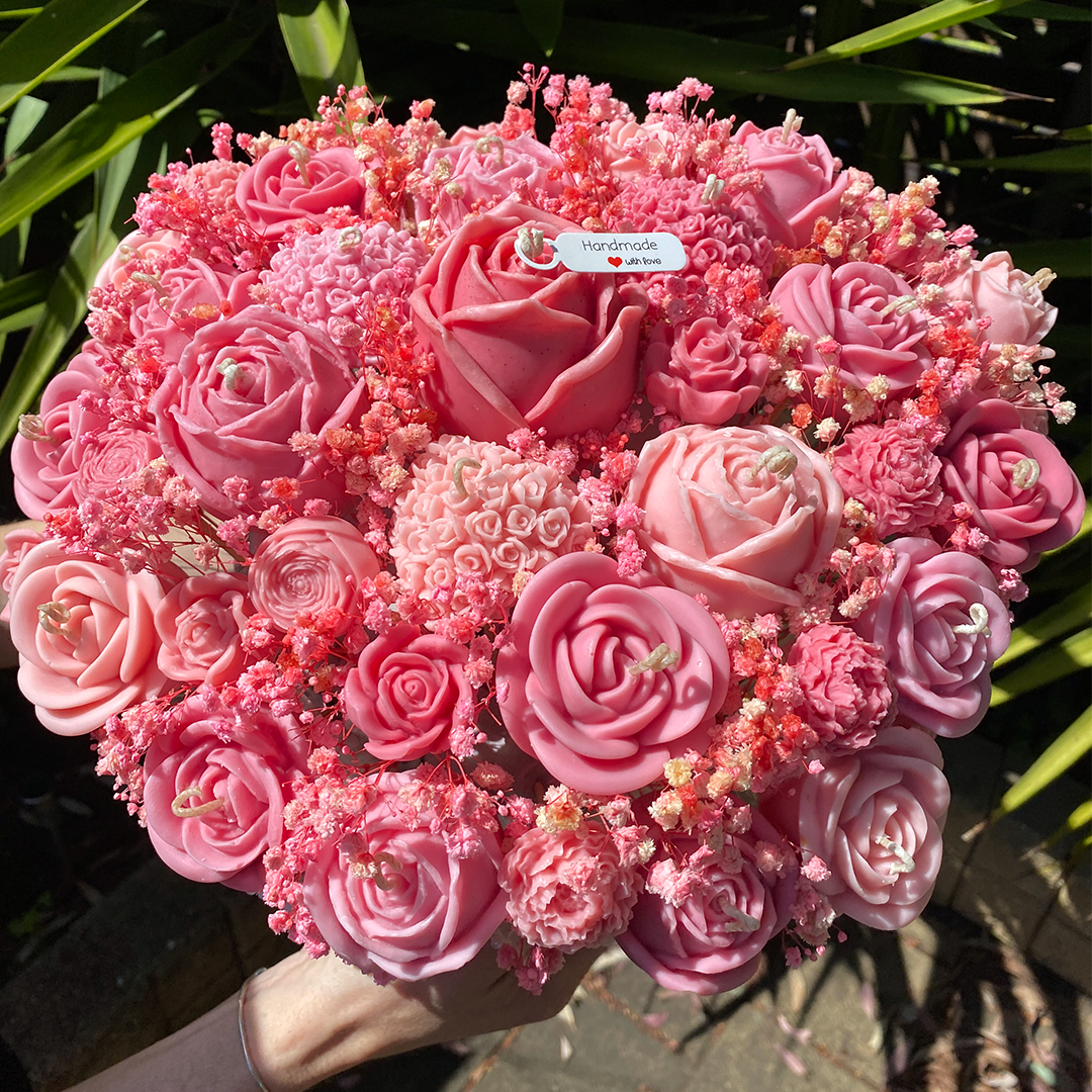 Bouquet of pink flowers with a visible brand tag against a green leafy background